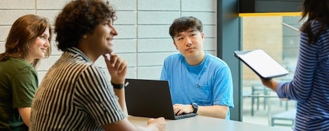 Students learning at a table.