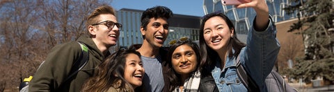 five students taking a selfie together