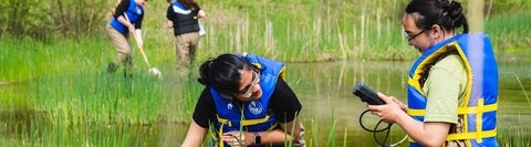 Two students in a creek