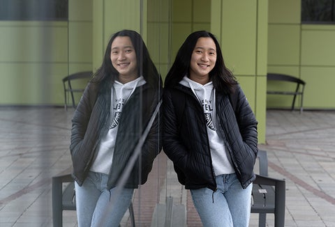 girl leaning against environment building