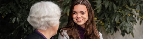 Student talking to an elderly lady