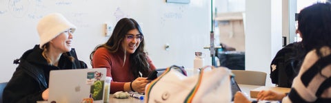 three students studying together