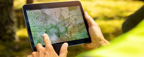 Person using a tablet with geography screening software. 