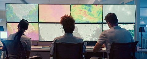 Team of three looking at heatmaps.