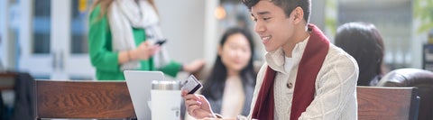 Student holding a credit card