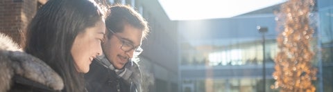 Two students sitting outside.