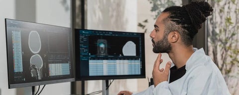 man looking at brain on computer
