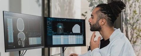 man looking at brain on computer