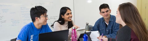 Students sitting around a table talking