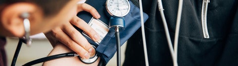 A blood pressure cuff around a person's arm