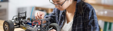 A student working on an electric model car