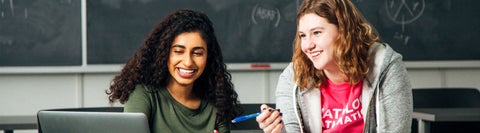 two students looking at a computer together