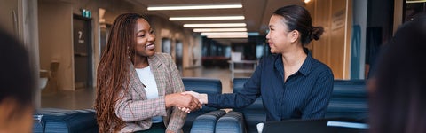 Two students shaking hands