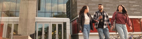 Three students walking together on campus