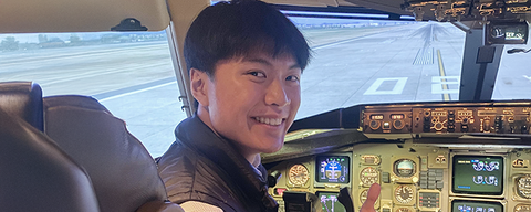 Daniel inside the cockpit of a plane.