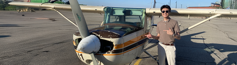 Daniel posing next to a plane.