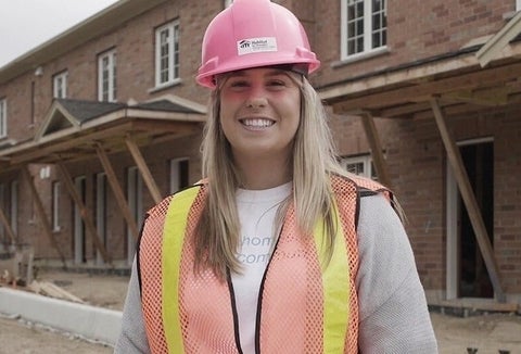 Student in construction zone wearing a pink hardhat