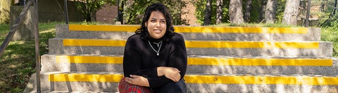 Student posing on outdoor staircase