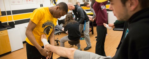 Student taping another student's foot