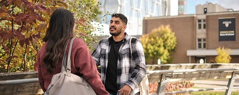 Two students on campus having a conversation