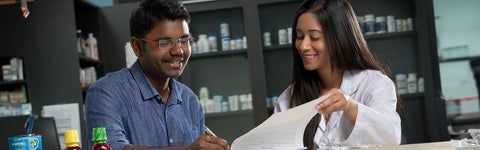 student signing paper