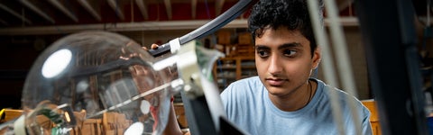 student looking at an experiment