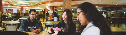 Students playing cards in the cafeteria
