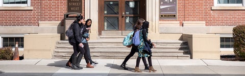 students walking in front of a building