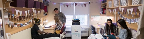 Students hanging out in a decorated dorm room