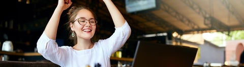 Student with arms in the air, celebrating