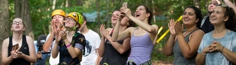 Recreation students on a field trip, cheering on people zip-lining
