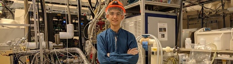 student in protective gear standing in a construction site