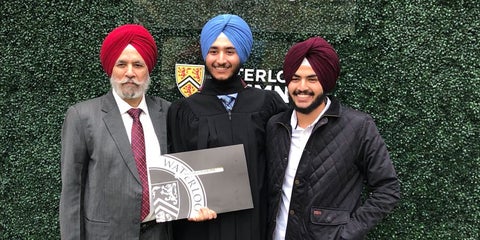 Dr. Singh, Harkanwal, and Jasmeet at Harkanwal’s graduation in front of a green background and and a sign that says #UWaterlooGrad