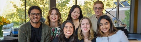 Group of seven students smiling at the camera