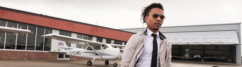 man in suit walking away from a small plane