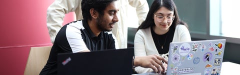 Two Software Engineering students work on a project together