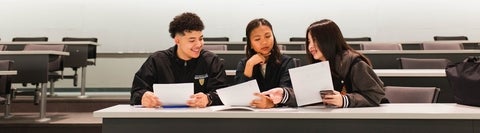 Three students in a classroom.