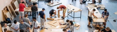 A large group of students building things out of cardboard