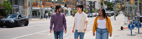 Three students walking together in Uptown Waterloo.
