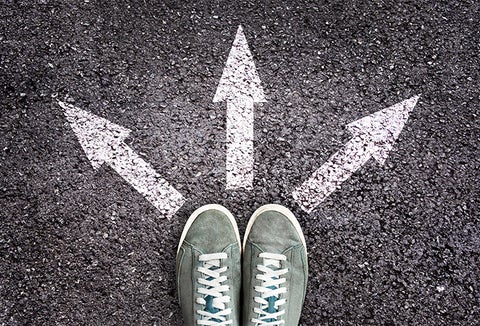 Image of feet in front of three directional arrows painted on the ground