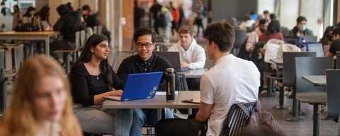 Three students studying together at the Student Life Centre cafeteria.