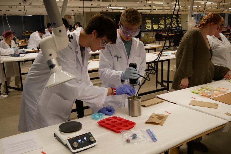 Students work in a lab with chemicals