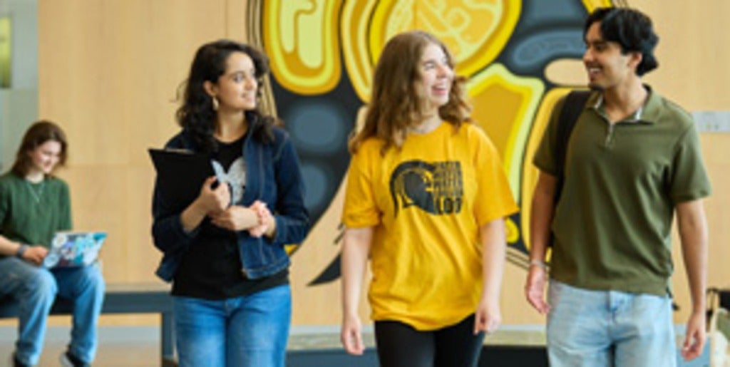 3 students walking toward camera