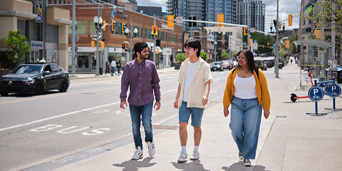 Three students walking together in Uptown Waterloo.