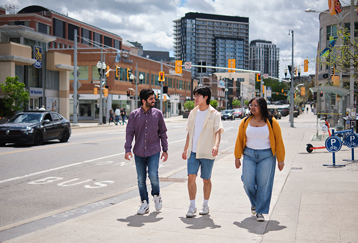 Three students walking together in Uptown Waterloo.
