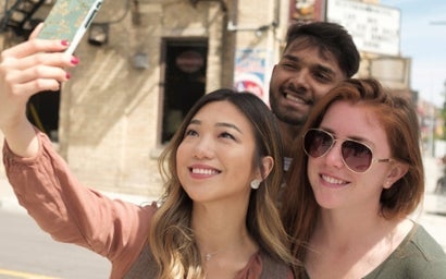 Three students taking a selfie together.