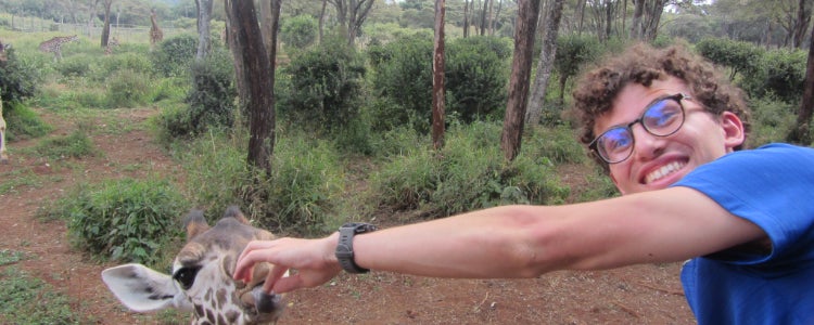 Sebastion feeding a giraffe