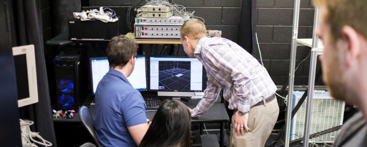People analyzing biomechenics data on a computer 