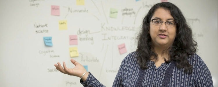 Akanksha stands in front of the students' completed mind map exercise