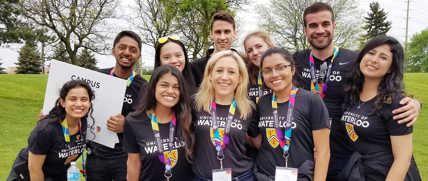 A group of student ambassadors wearing black t-shirts and colourful lanyards